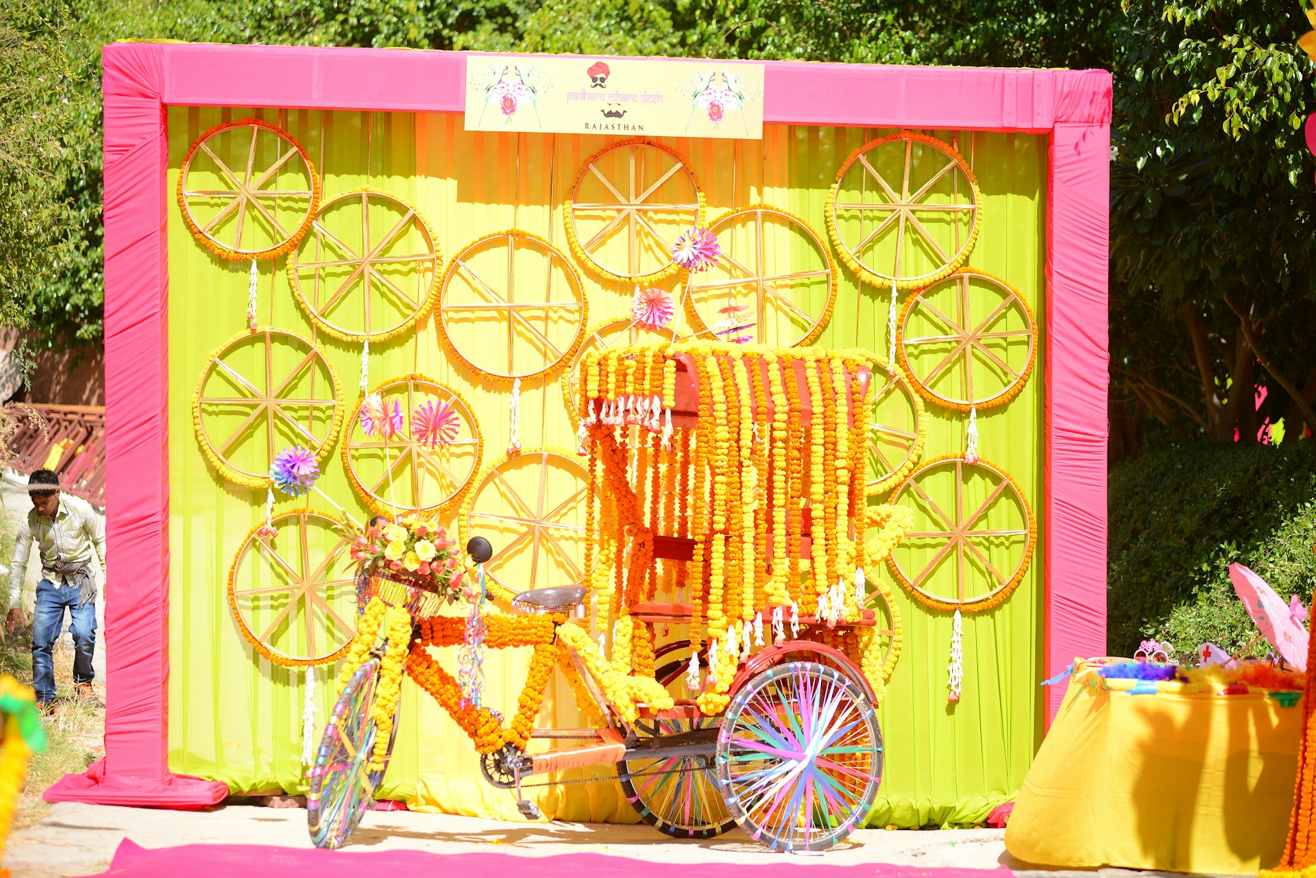 A decorated rickshaw displayed with floral and circular art.
